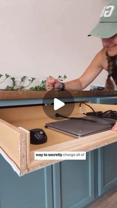 a woman in a baseball cap working on a desk