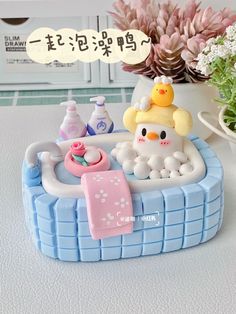 an image of a bathtub with soap and toys on the table in front of it