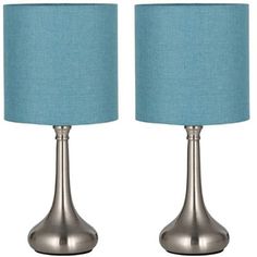 a pair of lamps with blue shades on each lamp and the same one in silver