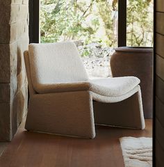 a white chair sitting in front of a window