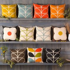 several decorative pillows on shelves in a room