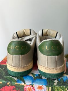 Authentic Gucci Screener Sneakers in excellent condition. Worn once but they don't fit me, sadly. Size 37, fit like a US 7.5. Classic Gucci sneakers featuring the Gucci stripes and classic green sole with bee design. Made in Italy. Please note: this style has some intentional distressing. Approximate measurements.Heel to toe: 10.5"Width: 3.75" Green Sneakers With Embroidered Logo And Round Toe, Green Round Toe Sneakers With Embroidered Logo, Green Low-top Sneakers With Embroidered Logo, Luxury Green Sneakers With Branded Insole, Vintage Low-top Sneakers With Embroidered Logo, Luxury Green Low-top Sneakers, Designer Green Lace-up Sneakers, Designer Green Low-top Custom Sneakers, Designer Low-top Sneakers With Gum Sole