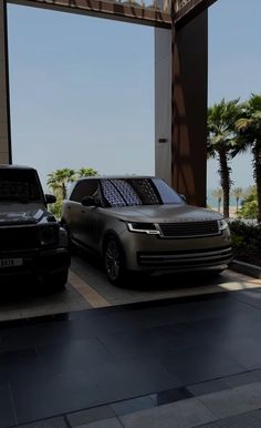 two cars parked next to each other in front of a building