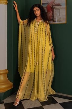 Yellow evil eye print full length kaftan with pleat details in the front and back and cutdana and bead embellished neckline. Paired with an inner.
Components: 2
Pattern: Printed
Type Of Work: Cutdana, Bead
Neckline: Round
Sleeve Type: Long
Fabric: Chiffon
Color: Yellow
Other Details: 
Attached lining
Occasion: Resort - Aza Fashions Evil Eye Print, Kaftan Pattern, Chiffon Kaftan, Kaftan Designs, Embellished Neckline, Western Dress, Eye Print, Beaded Neckline, Western Dresses