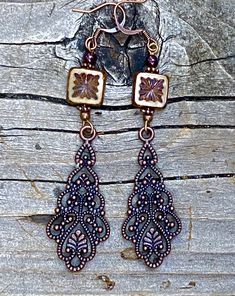 Long antique copper filigree earrings with Czech crystal and garnet gemstones. These long filigree earrings are very lovely, not too heavy! They are 3 inches long and 3/4 of an inch wide. The square table Kurt Czechoslovakian crystals really make the design pop. Garnet is the birthstone for January. All my jewelry comes gift boxed with a custom Shelly Mariposa Design butterfly card ready for gift giving, whether it is a gift for you or someone special. Your satisfaction is very important to me. Antique Copper Dangle Earrings, Antique Copper Drop Earrings, Antique Copper Earrings In Antique Gold, Antique Copper Dangle Jewelry, Vintage Copper Jewelry With Intricate Design, Vintage Copper Brown Earrings, Ornate Bronze Copper Jewelry, Vintage Brown Copper Earrings, Design Butterfly