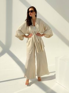 🌿Linen women kimono set with jacket and trousers. You can wear this stylish kimono at home or on the walk, apply kimono, as a cardigan, summer cloak. MORE: https://www.etsy.com/shop/ArtVyshyvankaUA?ref=seller-platform-mcnav%C2%A7ion_id&section_id=38397051 Fabric: 100% linen ----------------------------------------------------------------------------------------------------- Delivery time after shipping: USA 2-5 weeks Canada 4-6 weeks UK 3-5 weeks EU 2-4 weeks ----------------------------------- Beige Linen Kimono For Loungewear, Elegant Linen Kimono For Summer, Elegant Linen Summer Kimono, Beige Linen Kimono, Linen Kimono With Kimono Sleeves For Vacation, Linen Kimono With Kimono Sleeves For Loungewear, Elegant Spring Sets With Kimono Sleeves, Linen Kimono With Relaxed Fit, Casual Linen Kimono With Kimono Sleeves