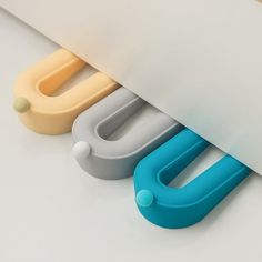 three different colored plastic objects sitting next to each other