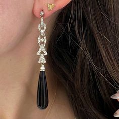 A striking pair of antique platinum hanging earrings. These earrings feature old European cut diamonds with Art Deco links. Set on top are are bezel-set diamonds. Set below the intricate diamond design are additional bezel-set diamonds that are attached to long polished onyx drops by a platinum link allowing movement. The total approximate weight of the diamonds is 1 carat. These earrings are handcrafted in platinum.
The measurements of the earrings from the top bezel diamond to the bottom onyx Chandler Earrings, Vintage Diamond Earrings, Pearl Earrings Designs, Asscher Cut Ring, Kunzite Ring, Fancy Diamond Ring, Rose Cut Ring, Vintage Jewelry Antique, Designer Diamond Jewellery