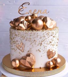 a white cake with gold decorations on top