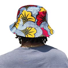 A unisex bucket cap made using authentic Ankara fabric. 58cm. Ankara, also known as African wax print or Dutch wax print, is a fabric characterized by vibrant patterns and colors. The fabric is made through a wax-resist dyeing technique called batik which creates distinct and colorful patterns. Ankara fabric is used to make a wide range of clothing and accessories, including dresses, skirts, shirts, and hats. Each pattern carries cultural meanings and stories making pieces made from this fabric not just fashion items but also carriers of African heritage and identity. Large Framed Artwork, Raffia Sun Hat, Dutch Wax Print, Bucket Cap, Raffia Hat, Wax Resist, African Wax Print, Ankara Fabric, Dyeing Techniques