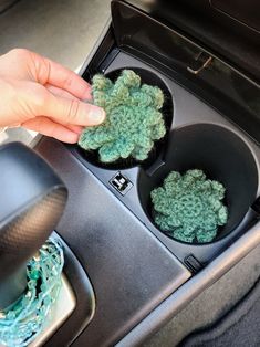 someone is cleaning the interior of a car with two bowls in it and one bowl on the floor