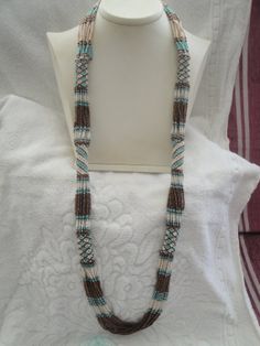 African Zulu beaded rope necklace in blue brown and cream by gulum, $75.00 Southwestern Style Brown Hand-strung Necklace, Artisan Brown Handwoven Necklace, Bohemian Beaded Necklace With Large Beige Beads, Bohemian Beige Beaded Necklace With Large Beads, Handmade Southwestern Brown Necklace, Handmade Bohemian Cream Beaded Necklace, Bohemian Handmade Beige Beads, Handmade Brown Southwestern Necklace, Artisan Beaded Brown Turquoise Necklace