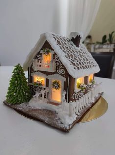 a gingerbread house decorated with lights and snow