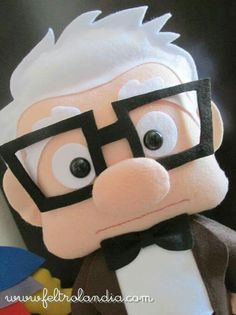 a close up of a stuffed animal wearing glasses