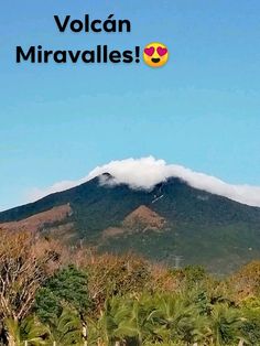 there is a mountain in the background with trees around it and text that reads volcano miravalies