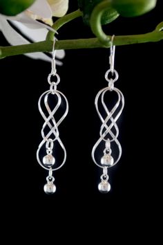 "*  * Sterling Silver Dangle Earrings for Women *  *   * 2 1/2\" long and 1/2\" wide  *These have a curvy double infinity design with balls. * Quality look and feel * Makes a great gift!         At the weight of four grams, these earrings are both comfortable to wear and durable. They are made of high polish silver and are very light reflective. You will enjoy many years of wear with these beautiful silver earrings." Hypoallergenic Infinity Sterling Silver Earrings, Silver Hypoallergenic Infinity Earrings, Double Infinity, Twist Jewelry, Tree Of Life Bracelet, Infinity Earrings, Infinity Design, Diy Wire Jewelry, Long Drop Earrings