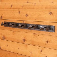 a close up of a metal object on a wooden wall