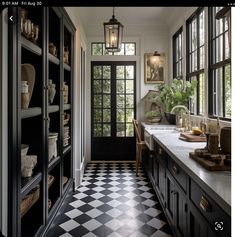 a black and white checkered floor in a kitchen with lots of windows on the wall