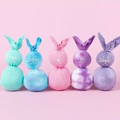 five different colored easter eggs in the shape of bunnies