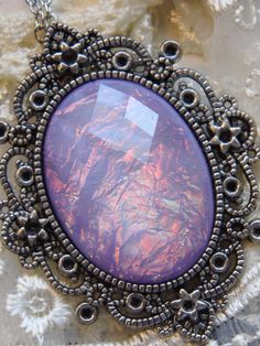 JUST LISTED - Vintage Inspired - Georgian & Victorian Cameo Jewlery - Lavender purple Moonstone FIre Opal OOAK Victorian princess Fantasy glass art Mythical Necklace Altered Art substantial in size at just a little over 2 INCHES Long Center is 40mmx30mm **thank you for taking the time to look at our items. Each item is handcrafted and attention to detail - We send each item in bubble packaging and with tracking to make sure items arrive in perfect condition. Please feel free to check out our Handmade Purple Fantasy Necklaces, Handmade Purple Fantasy Necklace, Handmade Iridescent Fantasy Jewelry, Purple Amethyst Fantasy Jewelry, Purple Fantasy Necklace For Gift, Fantasy Style Amethyst Purple Jewelry, Fantasy Style Purple Amethyst Jewelry, Fantasy Style Purple Necklace For Gift, Artistic Purple Pendant Jewelry