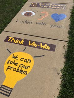 sidewalk art with words written on it and an image of a light bulb