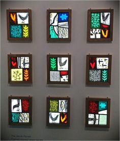 six square stained glass pieces mounted on a wall