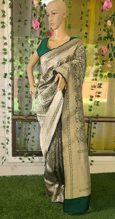 Directly from the core of Banaras, we present a handwoven dark green Banarasi saree for young ladies who would love to wear Banarasi Silk Brocade sarees that embody tastefulness and exhibit an old-world appeal. Wearing a Banarasi Silk Saree resembles saying something about class, legacy, and prosperity. Green Jamawar Pre-draped Saree For Festivals, Green Blouse Piece With Traditional Patterns, Festive Green Jamawar Pre-draped Saree, Green Jamawar Pre-draped Saree With Zari Weaving, Green Jamawar Pre-draped Saree, Green Tussar Silk Pre-draped Saree With Traditional Patterns, Green Jamawar Pre-draped Saree With Zari Work, Festival Green Blouse Piece, Green Pre-draped Saree With Zari Weaving For Transitional Season