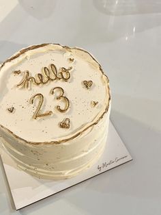 a birthday cake with the number 23 on it is sitting on top of a card