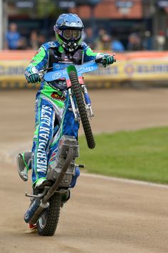 a man riding on the back of a dirt bike