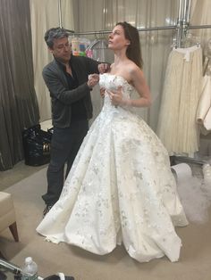 a man standing next to a woman in a wedding dress on a mannequin