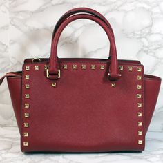 This studded Michael Kors shoulder bag measures approximately 8” x 13” x 4”. This is a used bag with minimal wear. Please closely inspect all photos before purchasing. Closure: Zip Strap Drop: 4” Color: Red Pockets: 3 Interior & 0 Exterior Material: Leather Style: Shoulder Bag Photos are Actual pictures, not stock photos. Authenticity Note: We have been trained to spot fake designer bags, and closely inspect each purse to verify authenticity. If we have any doubts, we NEVER sell it. That said, w Rectangular Travel Bags With Rivets, Elegant Rectangular Bag With Rivets, Elegant Rectangular Bags With Rivets, Studded Crossbody Bags For Everyday Use, Everyday Crossbody Bags With Studs, Studded Rectangular Bag For Everyday Use, Rectangular Studded Shoulder Bag For Everyday Use, Rectangular Everyday Bags With Studs, Everyday Use Rectangular Studded Shoulder Bag