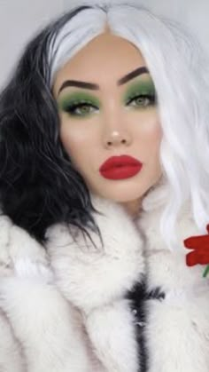 a woman with white hair and green eyes wearing a fur coat holding a red rose