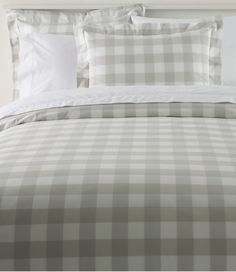 the comforter is made up with white and gray checkered sheets