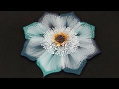 a blue and white flower with water droplets on it's petals is seen in this image