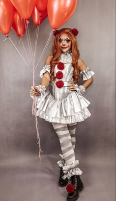 a woman dressed in clown makeup holding red balloons