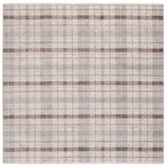 a beige and brown plaid rug on a white background