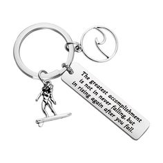 a keychain with a person holding a surfboard on it's side