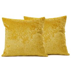 two yellow velvet pillows sitting next to each other