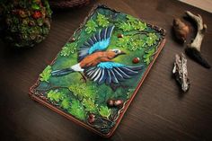 a bird painted on top of a wooden table next to other items and decorating