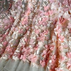 pink and white flowers are on the sheer fabric that has been made into a dress