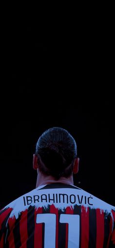 the back of a soccer player's shirt with his hair in a bun and undercut