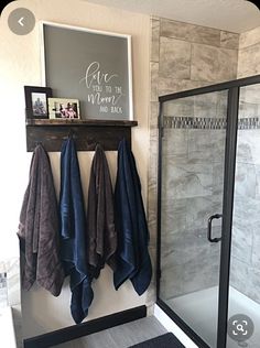 three towels hanging on the wall in a bathroom