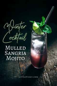 a drink in a tall glass with a mint garnish on the rim and text winter cocktail mulled sangria mojito