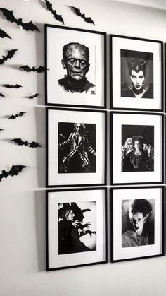 black and white photographs hanging on the wall in a room with bats flying around them