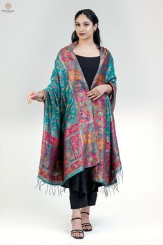 This exquisite Rama Green Kani dupatta, crafted from premium silk fabric, features intricate floral motifs alongside delicate figure patterns, woven with traditional expertise. Its vibrant color palette and rich design in Kani weave make it perfect for any festive occasion or grand celebration. Whether paired with a classic salwar suit or kurta set for a traditional ethnic look, or draped over a contemporary outfit, this elegant Pashmina Silk Shawl adds a touch of charm and sophistication to your ensemble, making you stand out in style. Color: Green Craft: Kani Weave Fabric: Silk Dimensions:                 L - 2.45 m                 W - 0.95  Dispatches in 2-3 business days Luxury Silk Dupatta With Zari Weaving, Festive Zari Weaving Dupatta Shawl, Festive Slub Silk Dupatta With Zari Weaving, Green Slub Silk Dupatta With Printed Motifs, Green Slub Silk Dupatta With Zari Weaving, Kashmiri Dupatta, Semi-stitched Pashmina Embroidered Dupatta, Floral Dupatta, Pashmina Silk