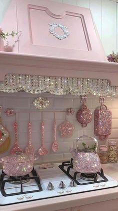 a pink stove top oven sitting inside of a kitchen