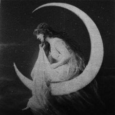 a woman sitting on the moon with her hands to her face