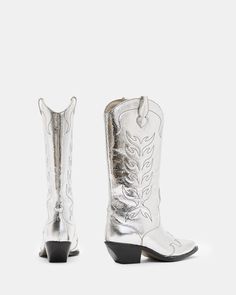 Staying true to their vintage roots, the Dolly Western Boots are made from metallic leather with delicate stitchwork all-over. The authentic shape is slightly chunkier in the heel for a modern spin. The perfect boot to pair with floral prints, oversized tees and mini skirts - make them your new go-to.   This style fits true to size Pointed toe Pull on Detailed stitchwork Comfortable fixed cushioned insole Metallic Cowboy Boots, Silver Cowboy Boots, Quinceanera Ideas, Oversized Tees, Go West, Wedding Boots, Zach Bryan, Leather Western Boots, Leather Cowboy Boots