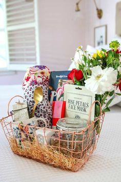 a basket filled with assorted items on top of a white table next to a window