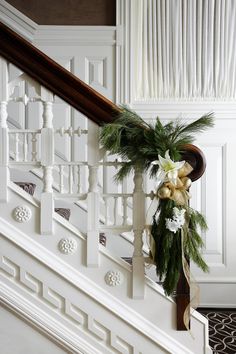 christmas decorations on the banisters and handrails in an elegant white house